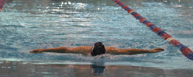 Boy swimming butterfly